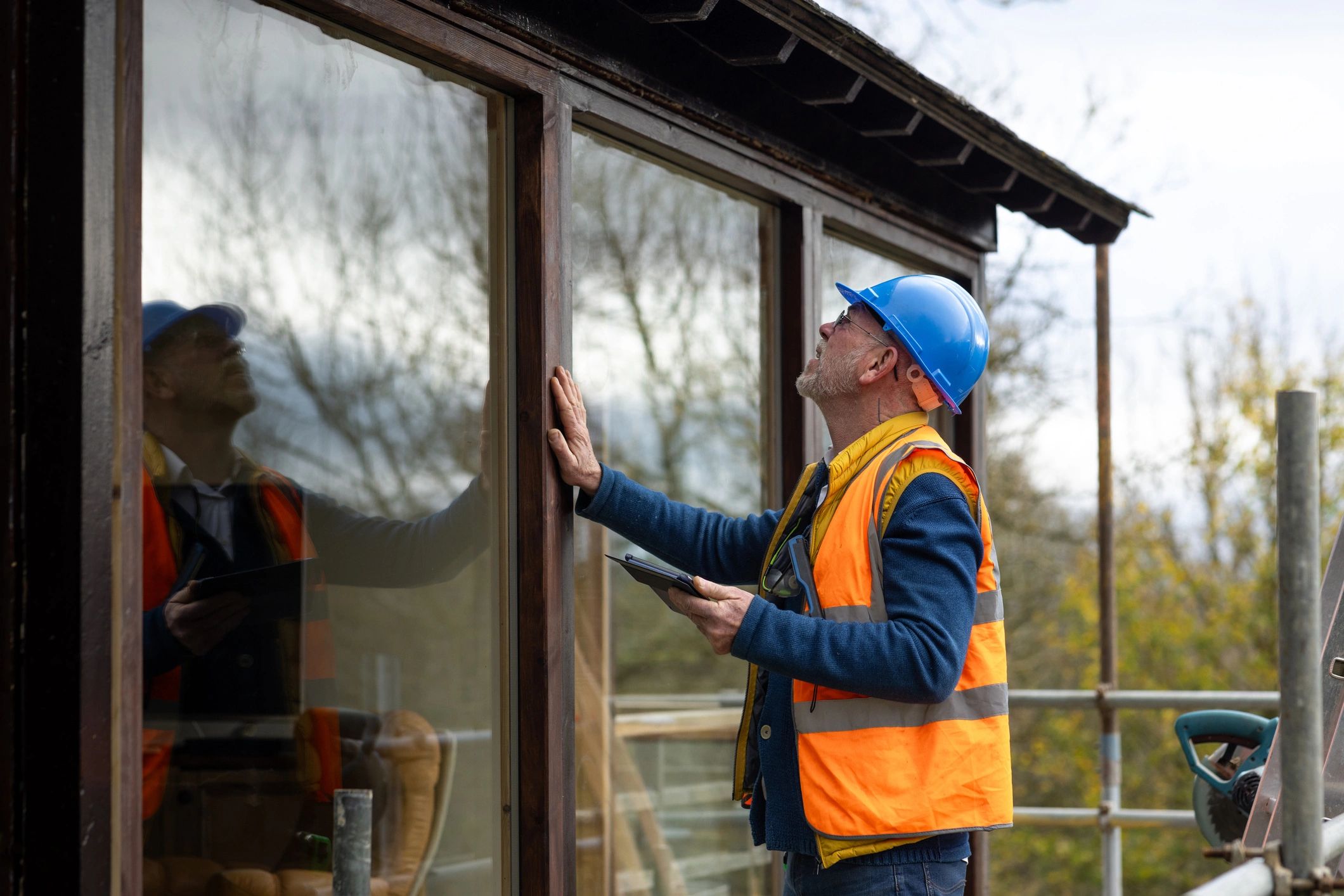 Building maintenance professional inspecting exterior work