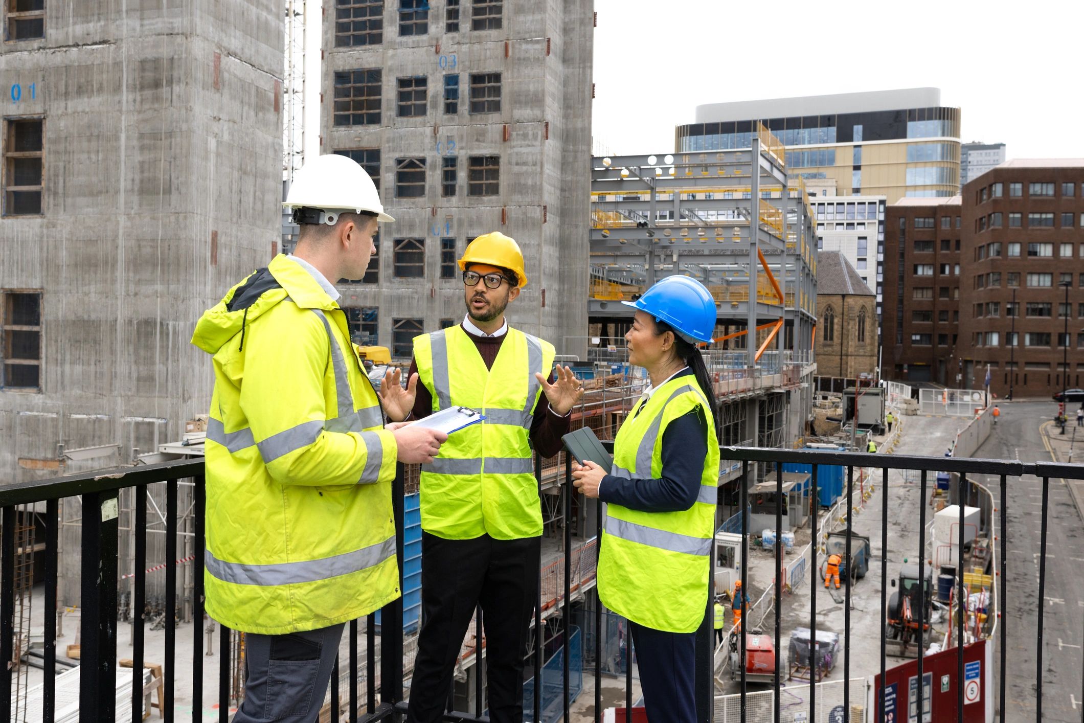 Maintenance professionals reviewing plans together outdoors